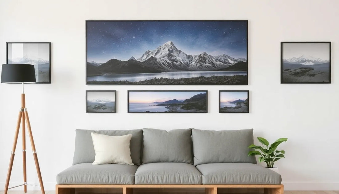 Stylish living room featuring a gray sofa, framed mountain landscape artwork, and a tall lamp, enhancing a cozy atmosphere.