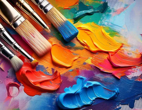 Colorful paint strokes in bright shades of orange, red, pink, and blue, accompanied by various paintbrushes on a textured canvas.