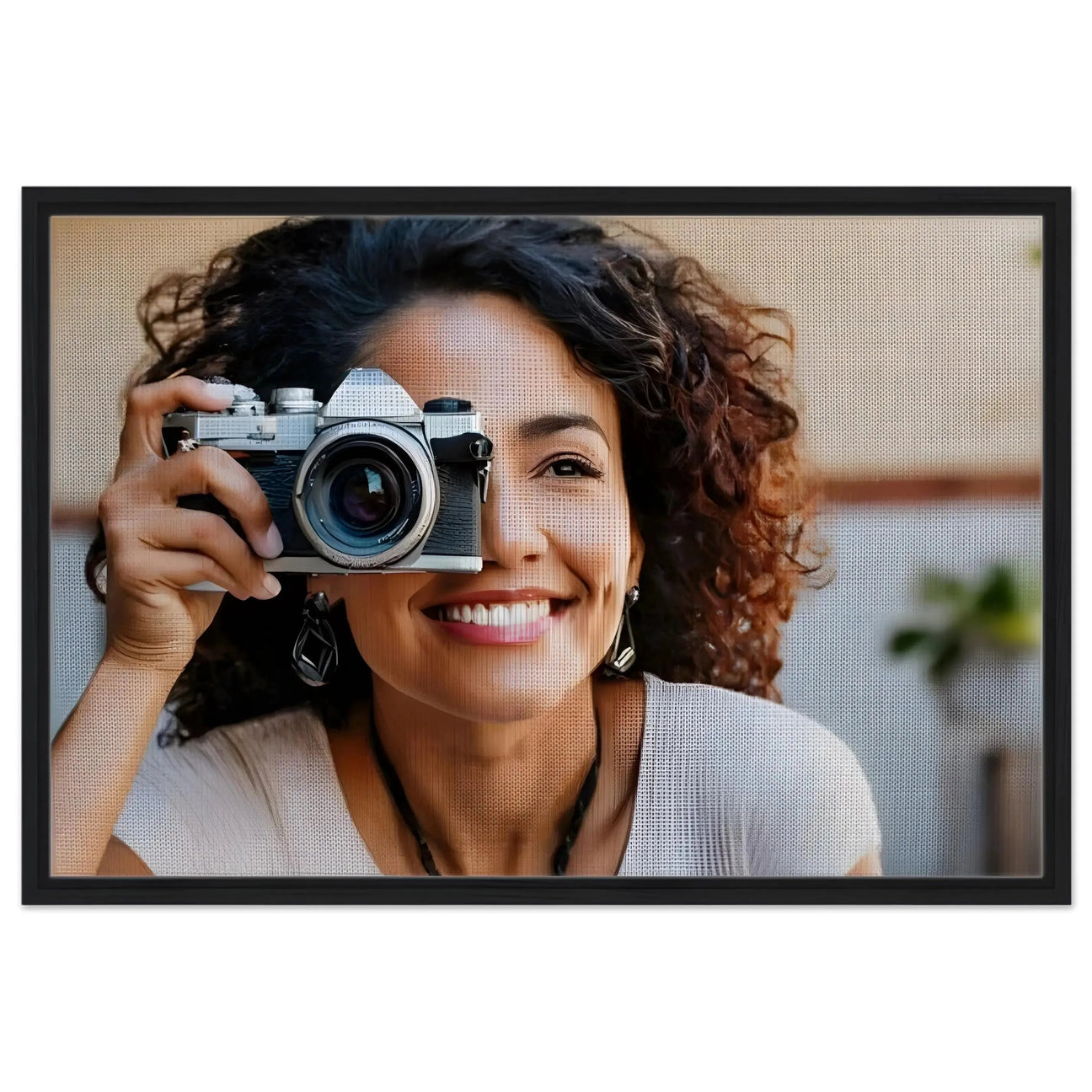 Framed canvas print featuring a smiling woman holding a vintage camera, showcasing vibrant colors and a stylish black frame.