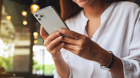 Personalized phone case with a sleek, clear design, held by a woman in a white shirt, showcasing custom photo options.