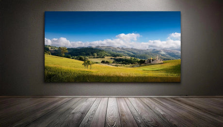 Vibrant landscape canvas print showcasing rolling green fields, a clear blue sky, and distant mountains, enhancing any room's decor.